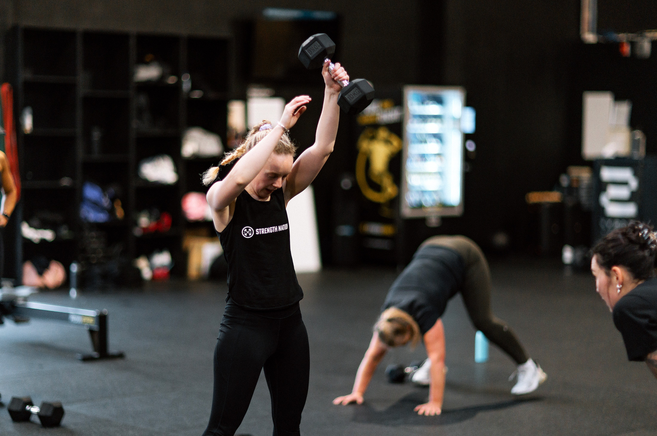 Woman Lifting Dumbells - Strength Nation